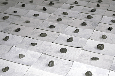 rows of stones on pieces of white paper