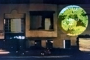 projected circular image onto a building at nighttime 