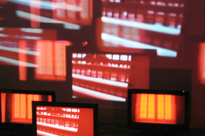 various flat screens and projected red, orange and white light