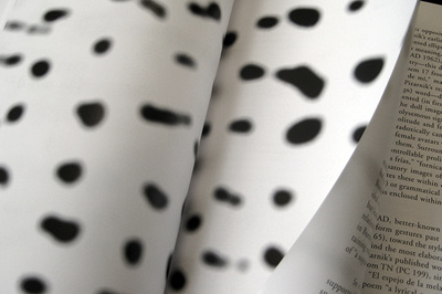 open book with black blotches on white pages