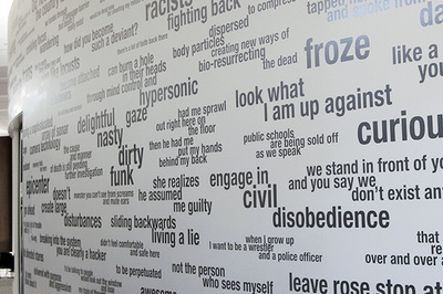 gray color words and phrases on white wall, hard to read