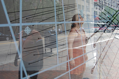 two people behind glass with blue and black lines