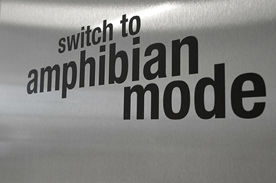 black letters reading "switch to amphibian mode" on metal background
